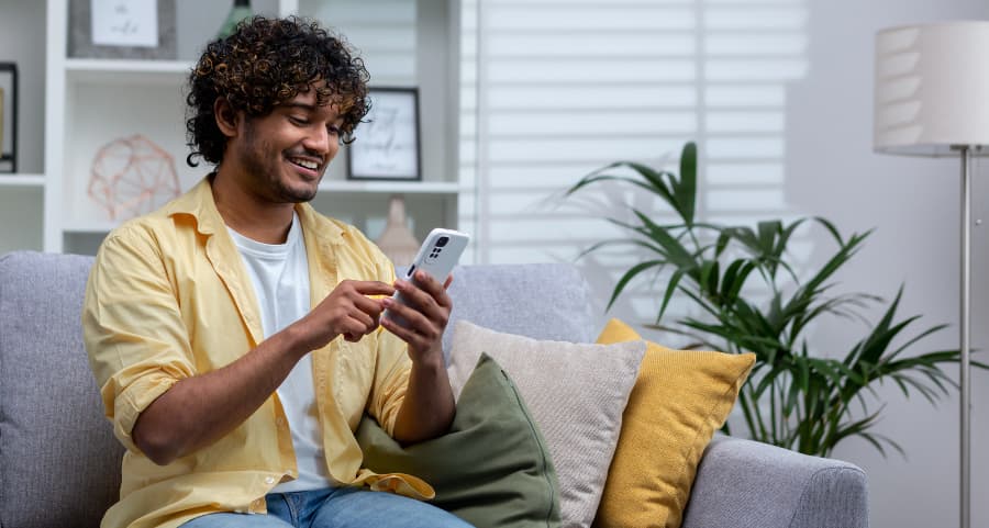 Homeowner using a home security app on his cell phone
